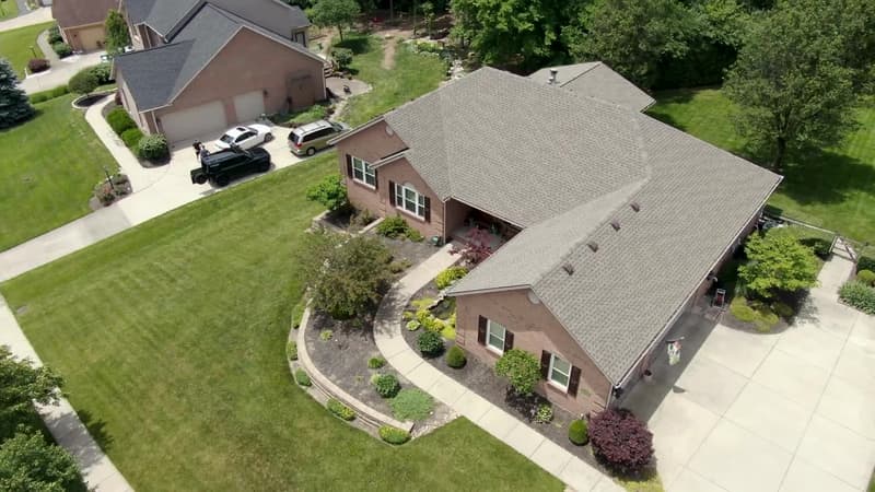 Aerial view of new shingle roof on brick ranch home
